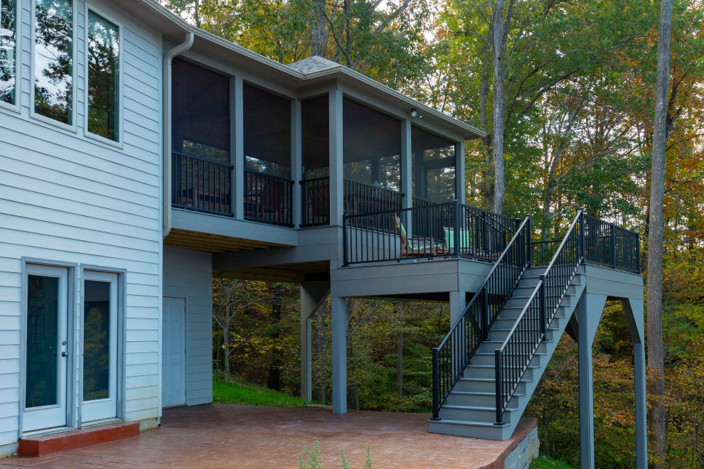 Idéer för en stor klassisk innätad veranda längs med huset, med betongplatta, takförlängning och räcke i metall