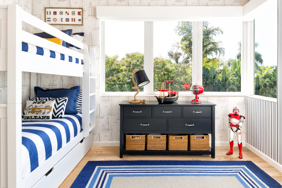 This is an example of a large beach style kids' bedroom for kids 4-10 years old and boys in Miami with light hardwood floors, multi-coloured walls and beige floor.