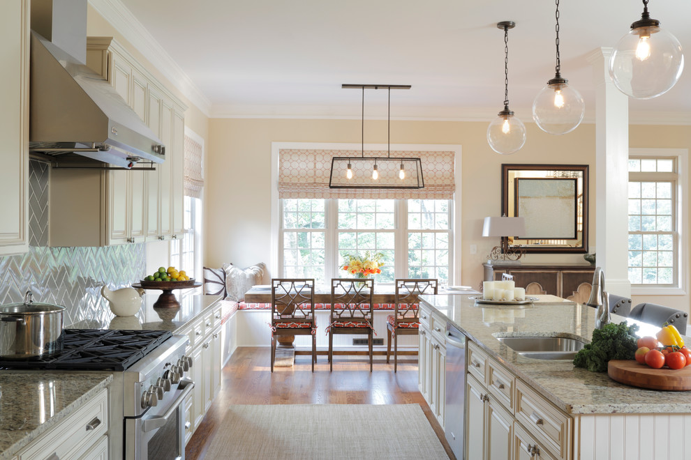 Design ideas for a large traditional galley eat-in kitchen in Atlanta with an undermount sink, raised-panel cabinets, white cabinets, granite benchtops, grey splashback, ceramic splashback, stainless steel appliances, medium hardwood floors and with island.