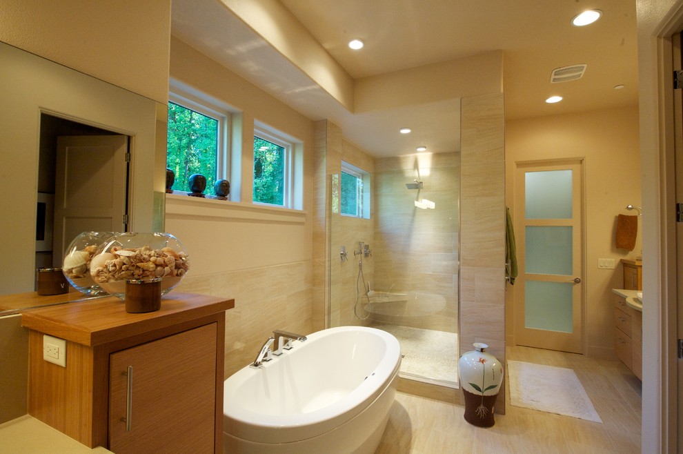 Inspiration for a contemporary bathroom in Portland with flat-panel cabinets, medium wood cabinets, a freestanding tub, an alcove shower and beige tile.