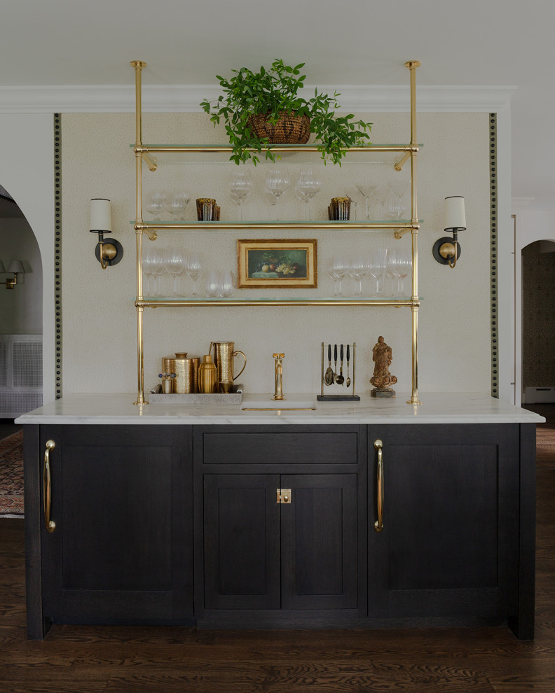 Inspiration for a single-wall wet bar in New York with an undermount sink, beaded inset cabinets, dark wood cabinets, marble benchtops, medium hardwood floors, brown floor and white benchtop.