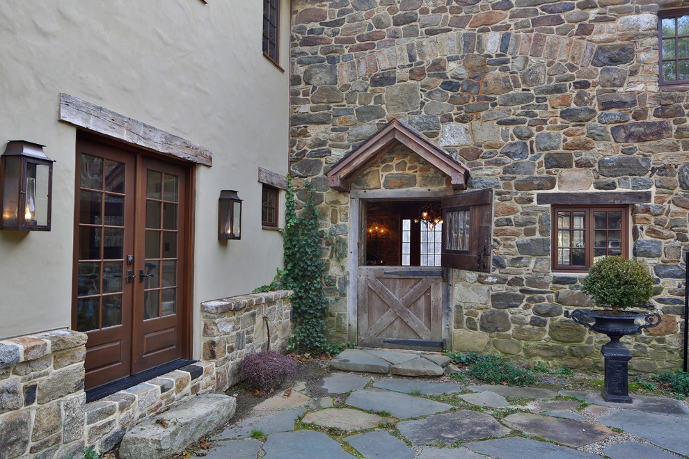 Photo of a country exterior in New York with stone veneer.