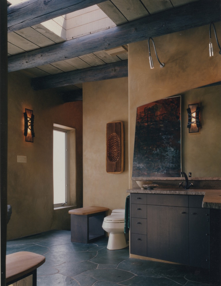 Large eclectic master bathroom in Albuquerque with flat-panel cabinets, blue cabinets, a hot tub, an alcove shower, a one-piece toilet, stone tile, slate floors and an undermount sink.