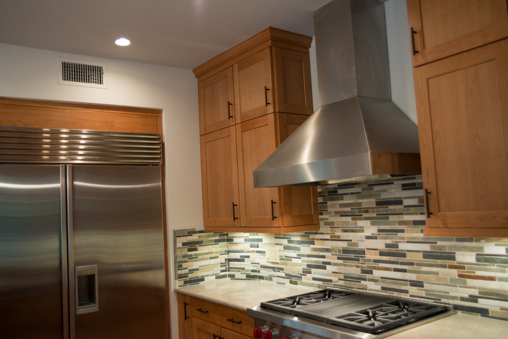Eat-in kitchen - large transitional l-shaped medium tone wood floor eat-in kitchen idea with a double-bowl sink, recessed-panel cabinets, medium tone wood cabinets, concrete countertops, multicolored backsplash, matchstick tile backsplash, stainless steel appliances and an island