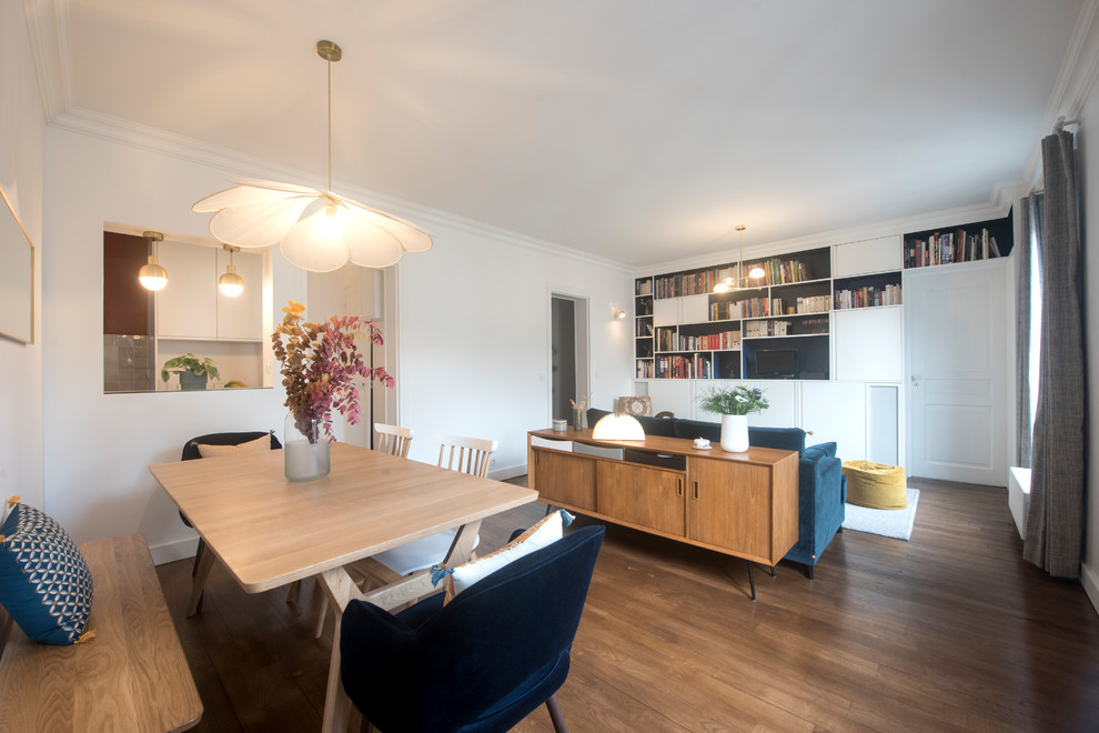 Mid-sized midcentury open plan dining in Paris with white walls, dark hardwood floors, no fireplace and brown floor.