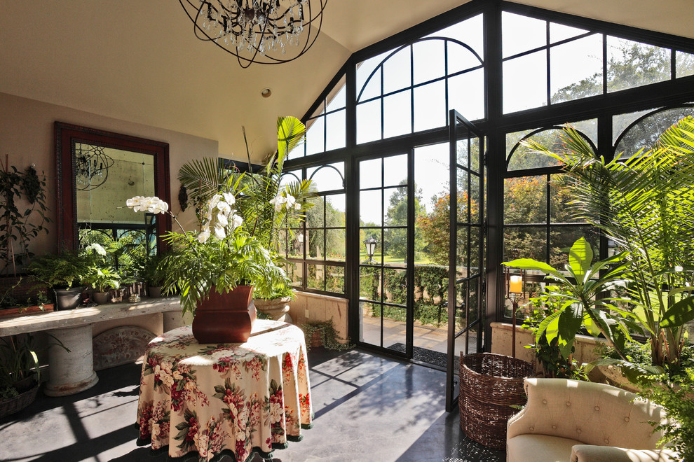 Inspiration for a timeless concrete floor and gray floor sunroom remodel with a standard ceiling