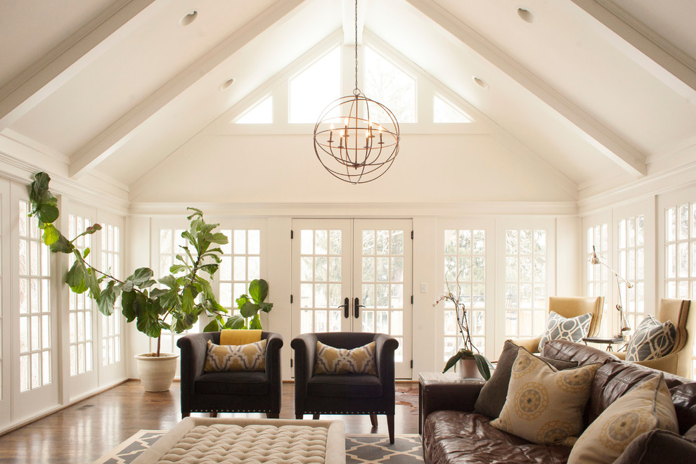 Inspiration for a large traditional family room in Kansas City with white walls and dark hardwood floors.