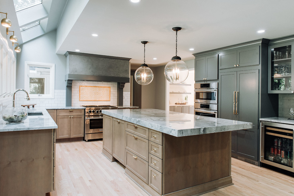 This is an example of a mid-sized modern single-wall kitchen pantry in Detroit with an undermount sink, shaker cabinets, grey cabinets, quartzite benchtops, yellow splashback, porcelain splashback, panelled appliances, light hardwood floors, with island, beige floor and grey benchtop.