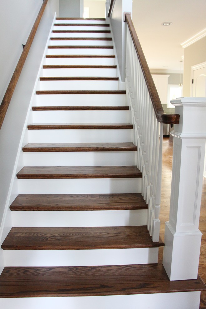 Design ideas for a mid-sized transitional wood straight staircase in Chicago with wood risers.