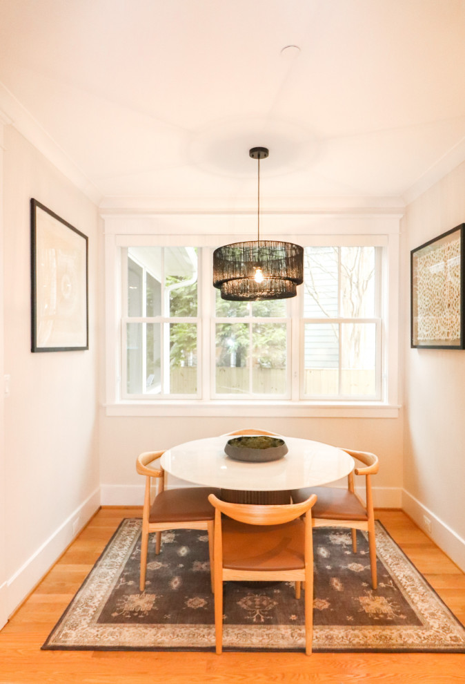 Photo of a mid-sized contemporary dining room in DC Metro with white walls, dark hardwood floors, a standard fireplace, brown floor, coffered and decorative wall panelling.