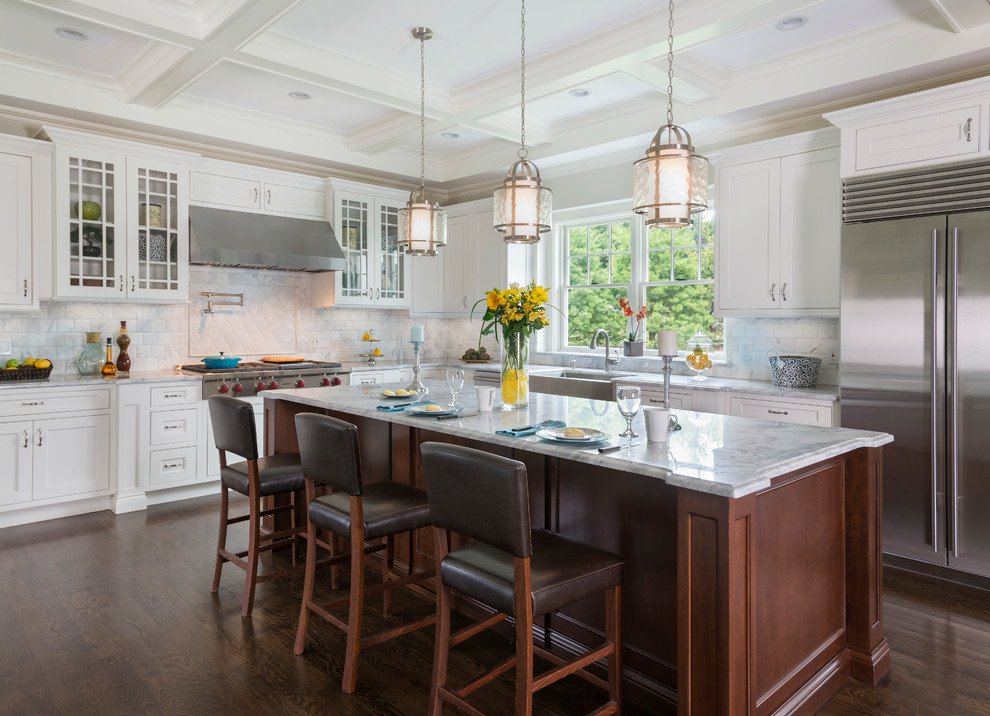 Inspiration for a large traditional l-shaped kitchen in Providence with a farmhouse sink, white cabinets, granite benchtops, ceramic splashback, stainless steel appliances, dark hardwood floors, with island, glass-front cabinets and white splashback.