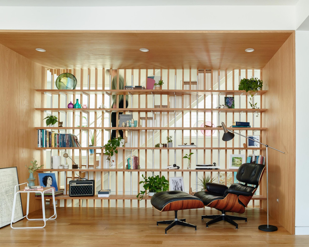 Photo of a midcentury open concept living room in Chicago with light hardwood floors, beige floor and wood walls.