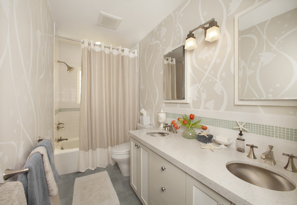 Photo of a small contemporary bathroom in San Francisco with an undermount sink, shaker cabinets, white cabinets, an alcove tub, a shower/bathtub combo, white tile, subway tile, beige walls, engineered quartz benchtops, a one-piece toilet and porcelain floors.