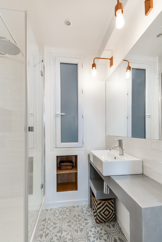 This is an example of a small scandinavian 3/4 bathroom in Paris with white walls, concrete benchtops, white tile, subway tile, a vessel sink, open cabinets and an alcove shower.