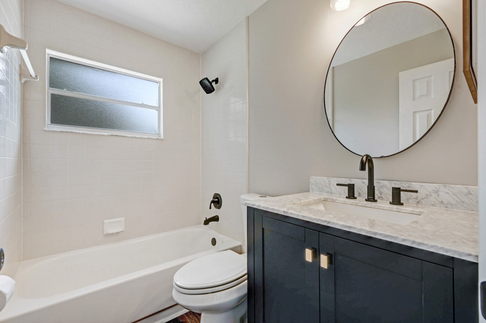 Bathroom - small cottage kids' vinyl floor, gray floor and single-sink bathroom idea in Orlando with shaker cabinets, blue cabinets, gray walls, an undermount sink, quartz countertops, gray countertops and a freestanding vanity