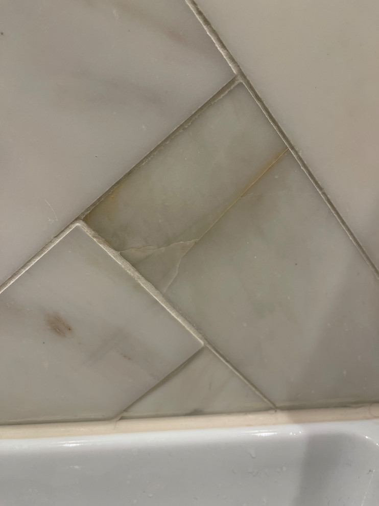 Newly installed marble tiles cracking