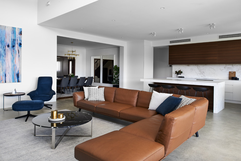 Photo of a large contemporary open concept living room in Sydney with white walls, concrete floors and grey floor.