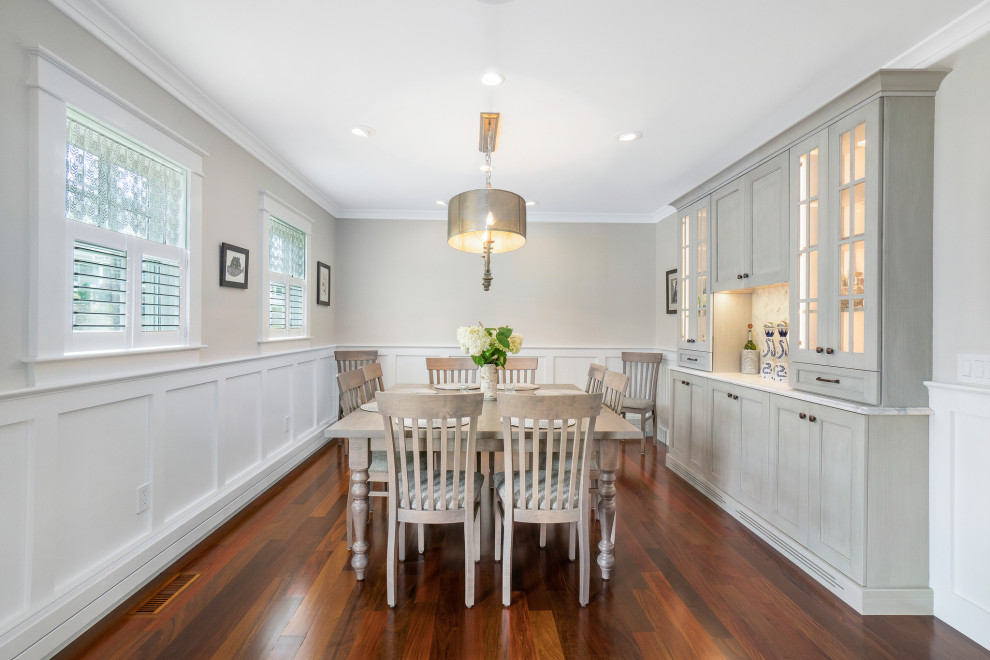 Mid-sized beach style kitchen/dining combo in Providence with grey walls, medium hardwood floors, brown floor and panelled walls.