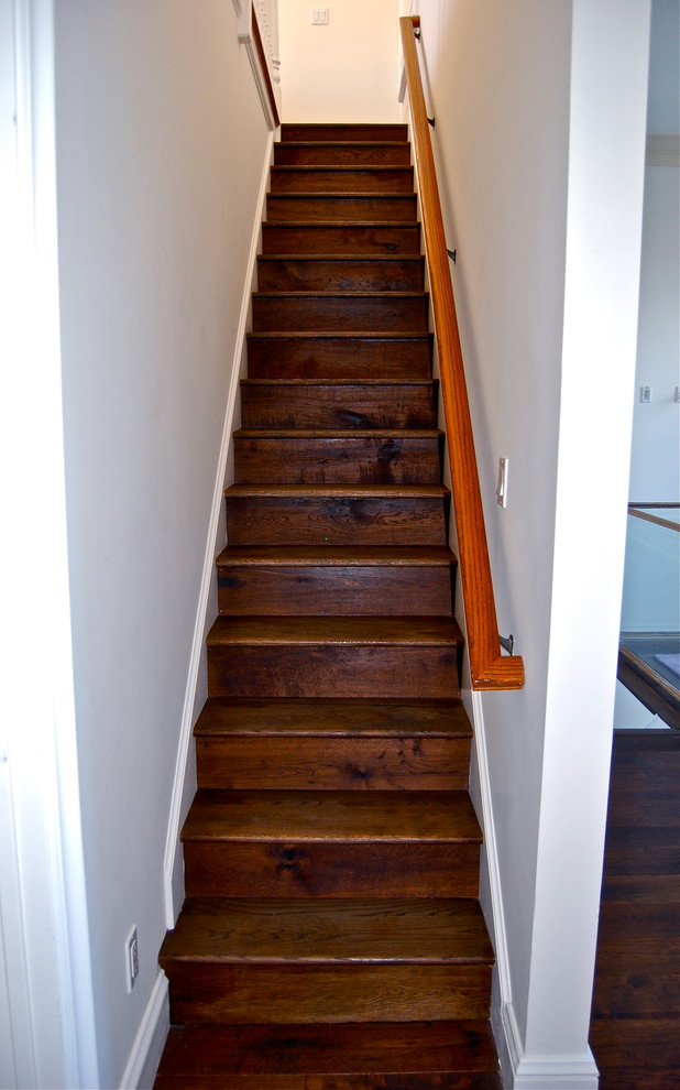 This is an example of a small country wood straight staircase in Los Angeles with wood risers.