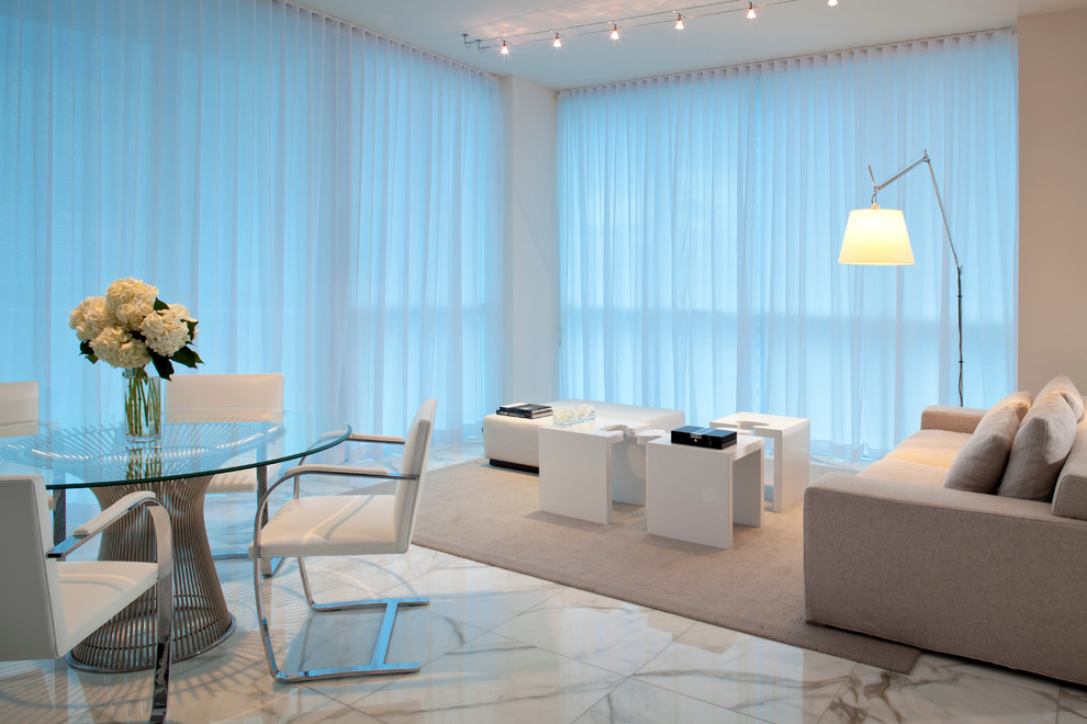 This is an example of a contemporary formal open concept living room in Miami with marble floors.
