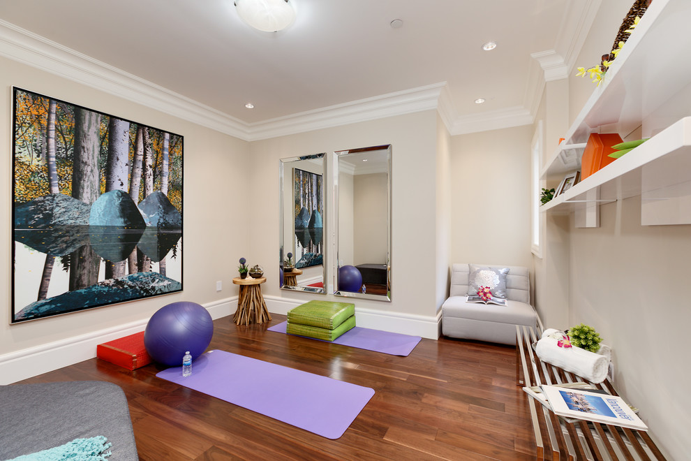 Traditional home yoga studio in Vancouver with beige walls and dark hardwood floors.