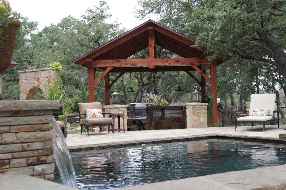 Example of a mid-sized mountain style backyard stone and rectangular lap pool fountain design in Austin