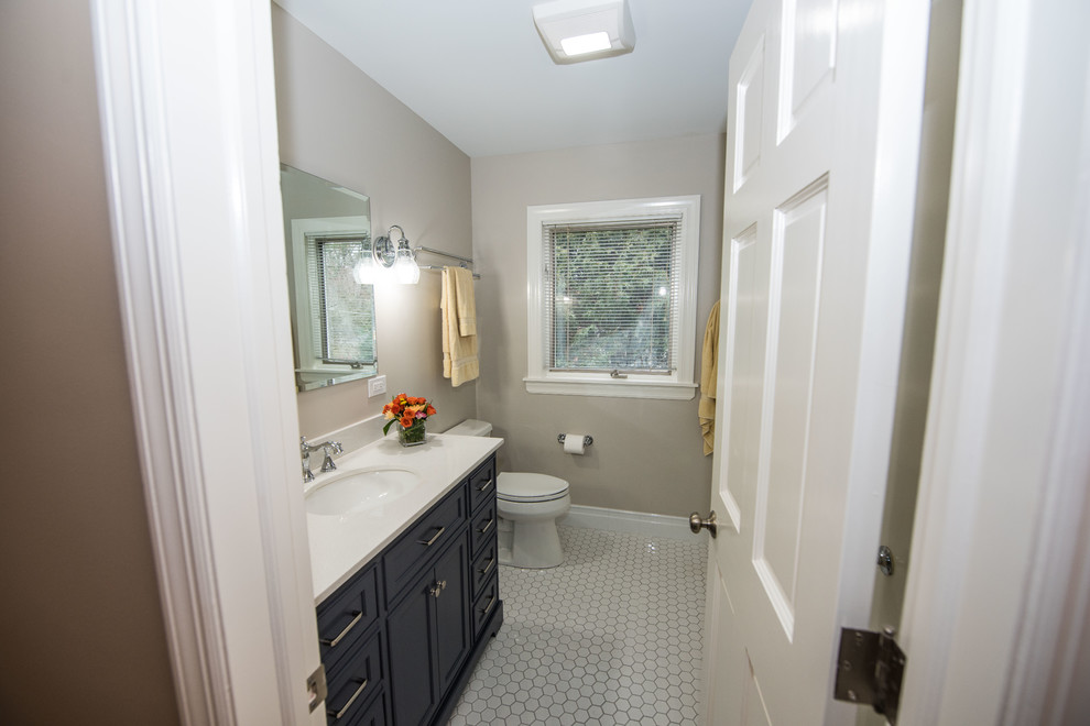 Small 3/4 ceramic tile, white floor and single-sink bathroom photo in Chicago with shaker cabinets, black cabinets, a one-piece toilet, beige walls, a drop-in sink and a built-in vanity