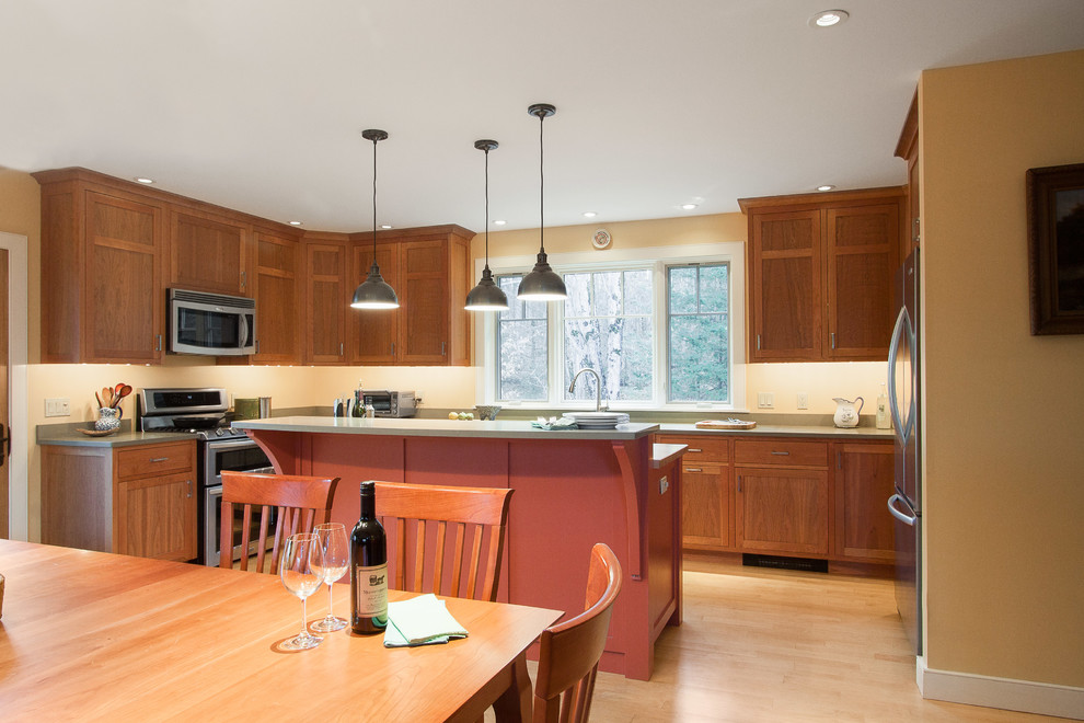 Eat-in kitchen - mid-sized transitional l-shaped light wood floor and brown floor eat-in kitchen idea in Burlington with an undermount sink, recessed-panel cabinets, dark wood cabinets, concrete countertops, brown backsplash, stainless steel appliances and an island