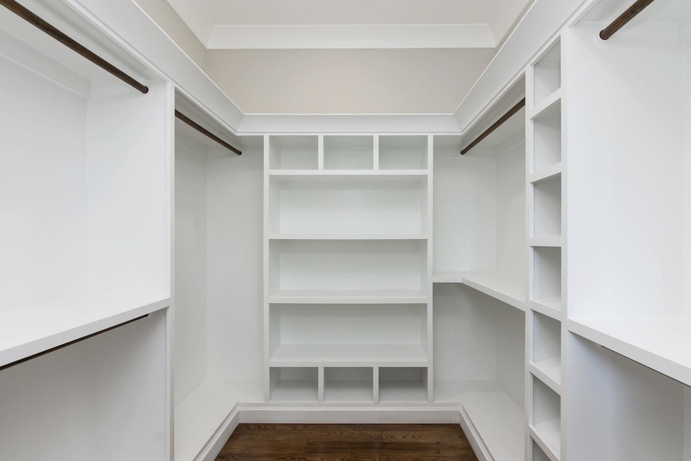 Photo of a large country gender-neutral walk-in wardrobe in Raleigh with medium hardwood floors and brown floor.