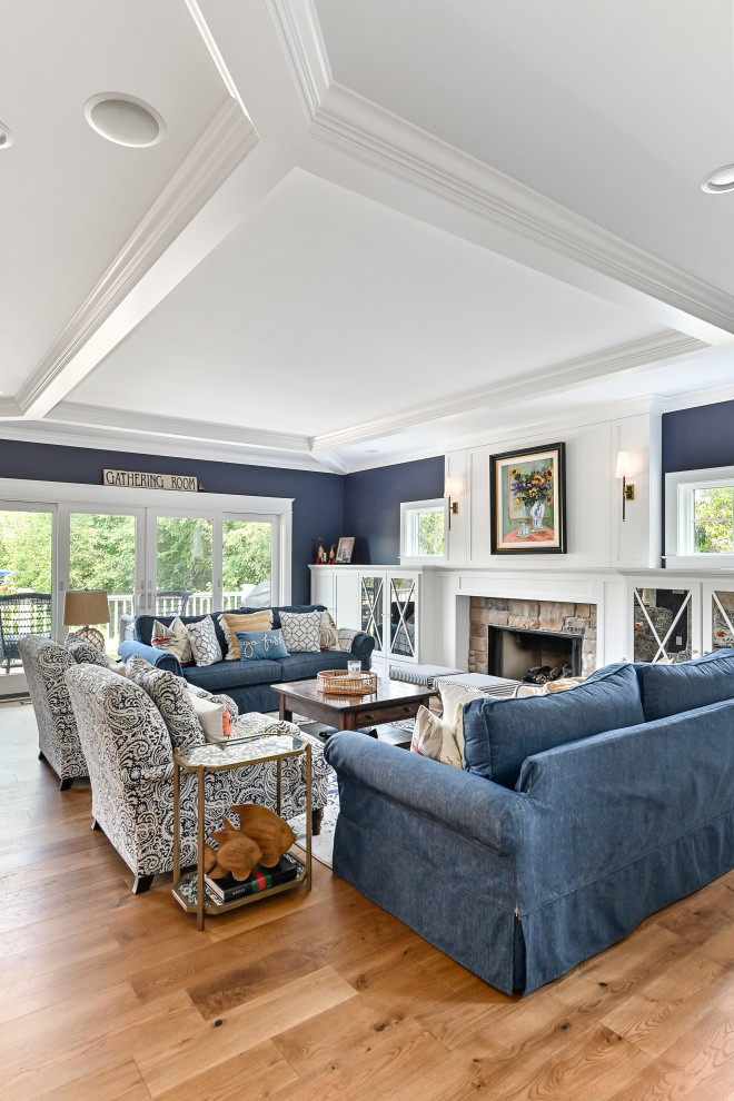 Design ideas for an expansive transitional formal open concept living room in Milwaukee with blue walls, vinyl floors, a standard fireplace, a stone fireplace surround, no tv, brown floor, coffered and panelled walls.