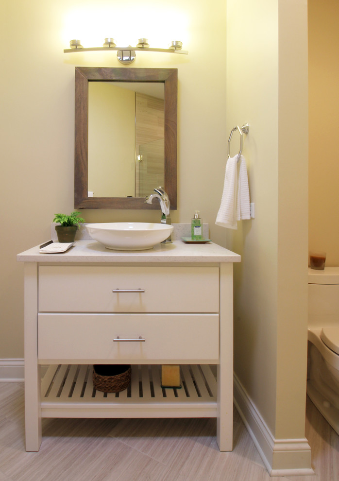Alcove shower - rustic gray tile and porcelain tile porcelain tile alcove shower idea in Chicago with furniture-like cabinets, white cabinets, a one-piece toilet, beige walls, a vessel sink and quartz countertops