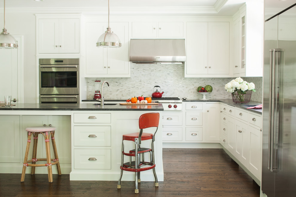 Inspiration for a large timeless l-shaped dark wood floor kitchen remodel in New York with an undermount sink, shaker cabinets, white cabinets, granite countertops, multicolored backsplash, stainless steel appliances, gray walls and an island