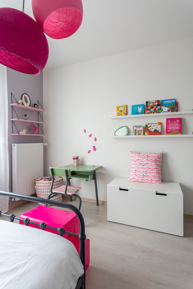 Photo of a mid-sized contemporary kids' study room for kids 4-10 years old and girls in Bordeaux with white walls and light hardwood floors.