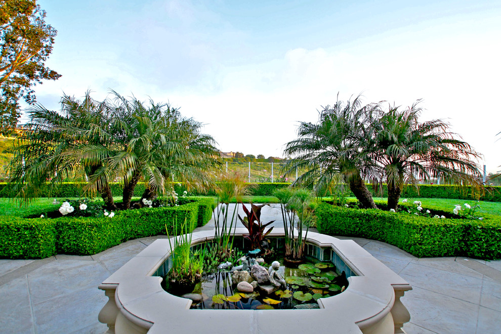 Inspiration for a mediterranean courtyard garden in Orange County with a water feature.