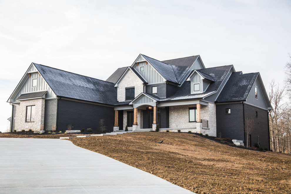 Inspiration for a large transitional multicolored two-story mixed siding and board and batten exterior home remodel in Indianapolis with a shingle roof and a black roof