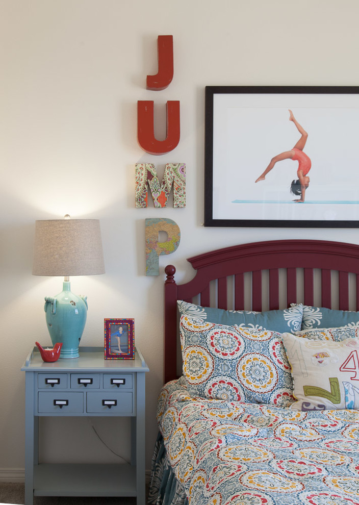 Photo of a transitional kids' room for girls in Los Angeles with beige walls and carpet.