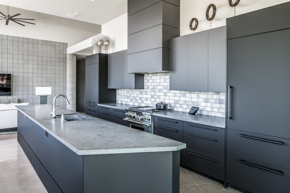 Inspiration for a large contemporary single-wall eat-in kitchen in Phoenix with an undermount sink, flat-panel cabinets, black cabinets, concrete benchtops, grey splashback, metal splashback, stainless steel appliances, porcelain floors, with island and multi-coloured floor.