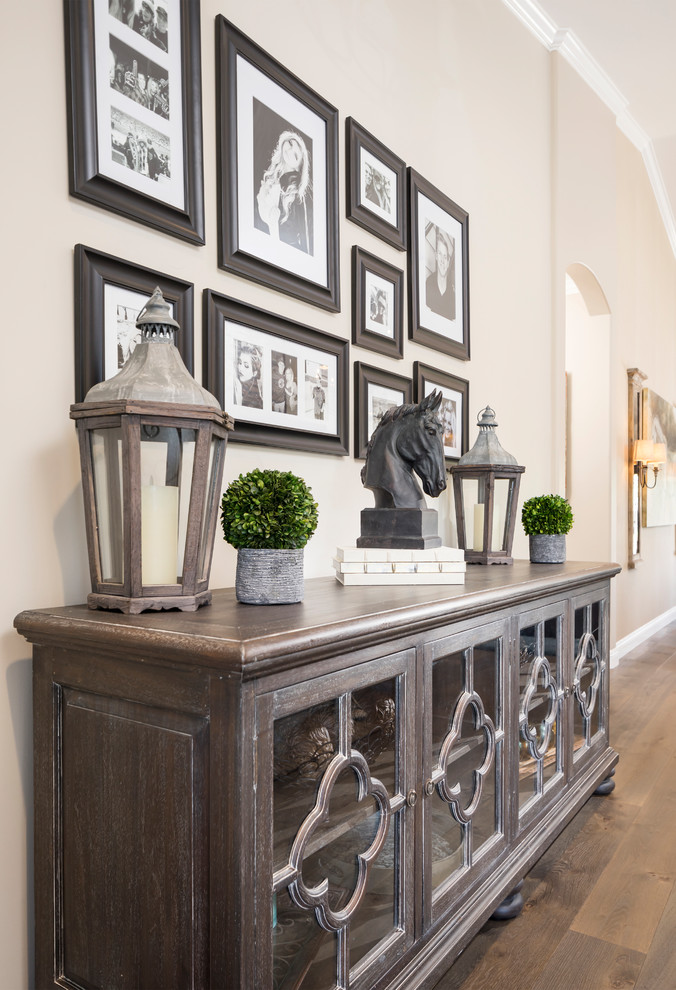 Inspiration for a large rustic medium tone wood floor and brown floor foyer remodel in Phoenix with beige walls and a black front door