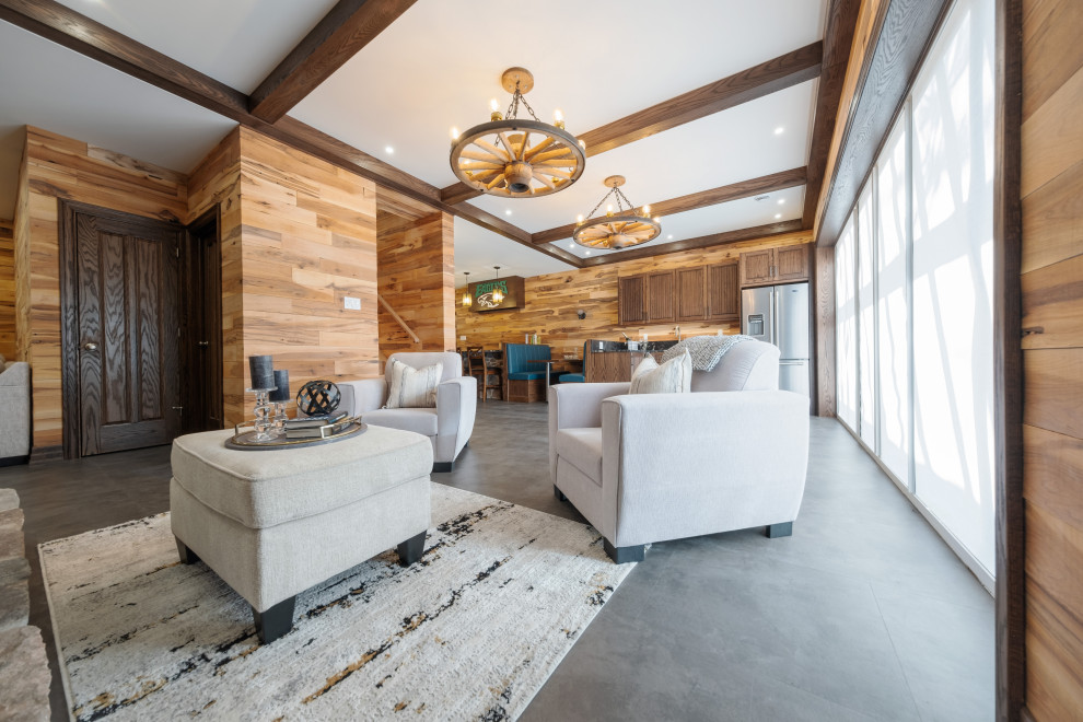 Large mountain style walk-out vinyl floor, gray floor, exposed beam and wood wall basement photo with a bar, multicolored walls, a standard fireplace and a stone fireplace