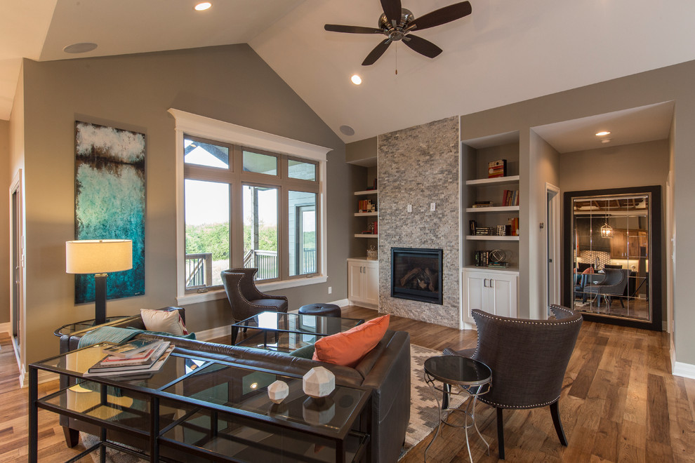 Inspiration for a mid-sized transitional formal open concept living room in Wichita with grey walls, medium hardwood floors, a standard fireplace, a stone fireplace surround, no tv and grey floor.