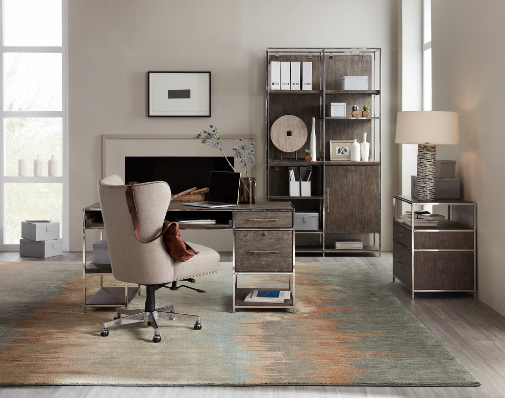 Inspiration for a large contemporary home office in Denver with beige walls, porcelain floors, a standard fireplace, a plaster fireplace surround, a freestanding desk and grey floor.