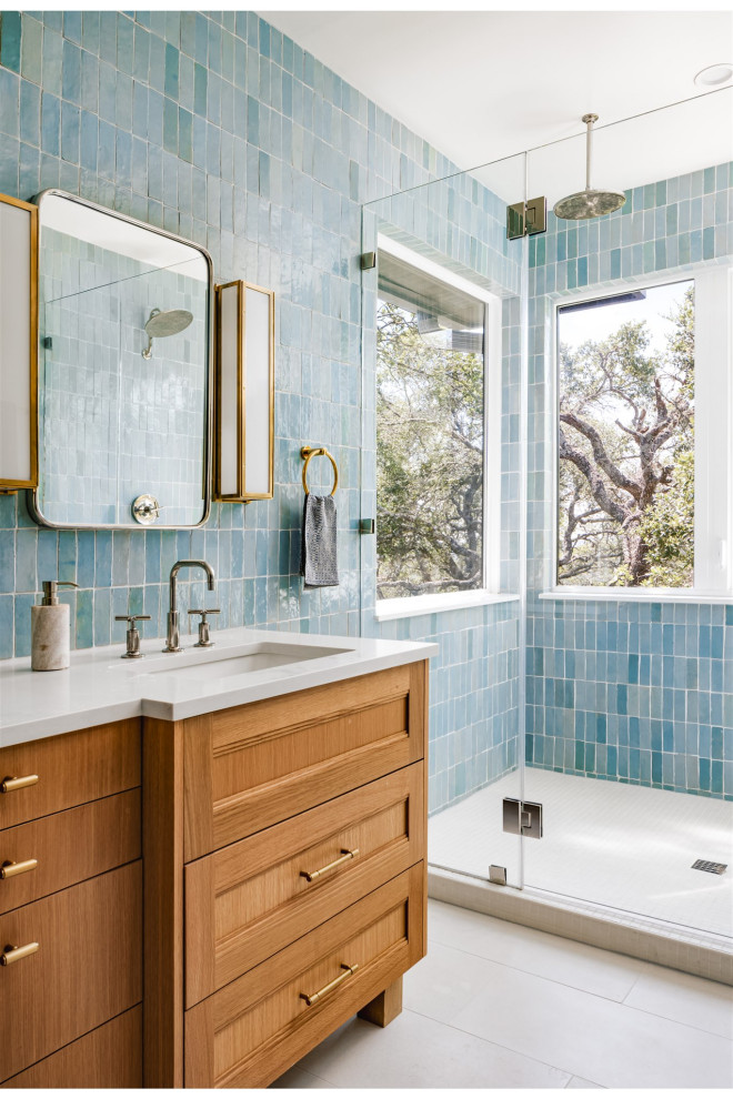 Inredning av ett klassiskt en-suite badrum, med en dusch i en alkov, blå kakel, vitt golv och dusch med gångjärnsdörr