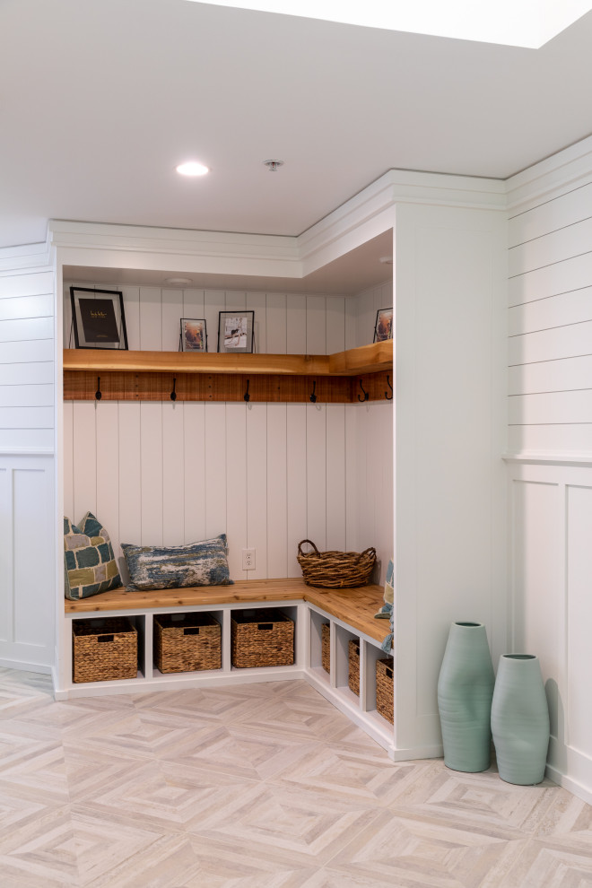 Mudroom - coastal ceramic tile, gray floor, tray ceiling and wainscoting mudroom idea in Other with white walls