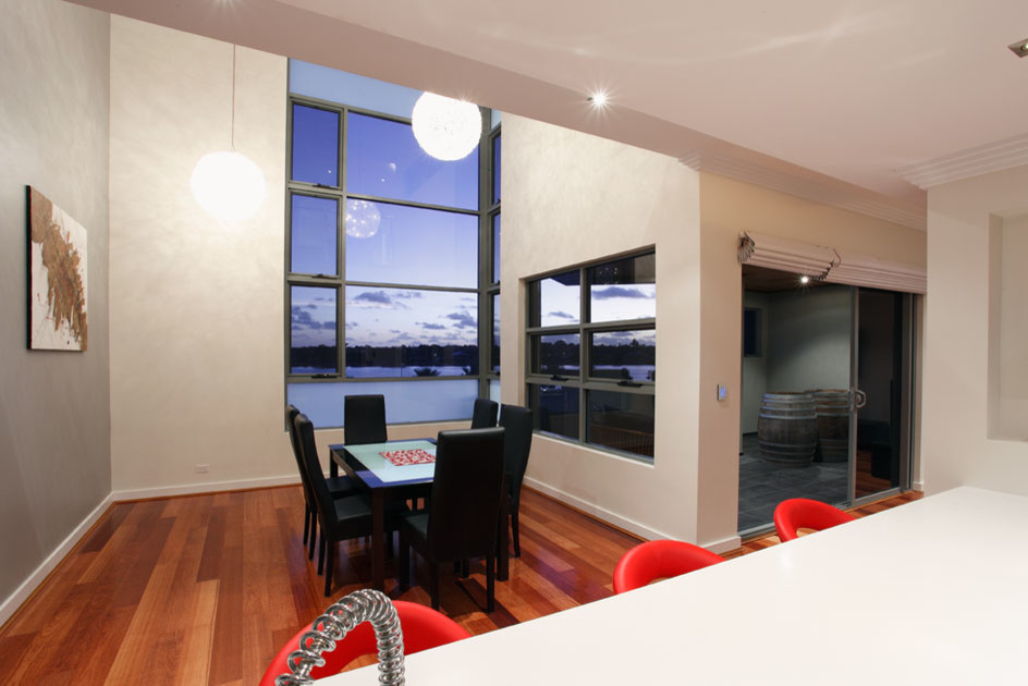 Inspiration for a small contemporary open plan dining in Perth with medium hardwood floors and no fireplace.