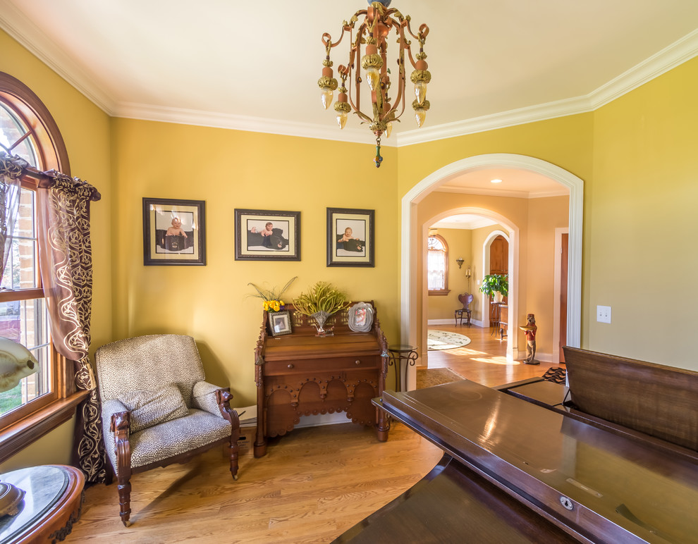 Inspiration for a mid-sized traditional enclosed living room in Chicago with a music area, yellow walls, medium hardwood floors, no tv, no fireplace, blue floor, wallpaper and wallpaper.