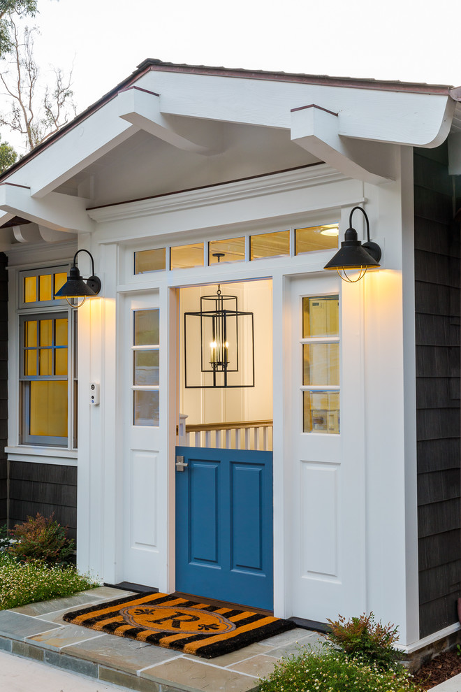 This is an example of a mid-sized beach style front door in San Diego with grey walls, granite floors, a dutch front door, a blue front door and grey floor.