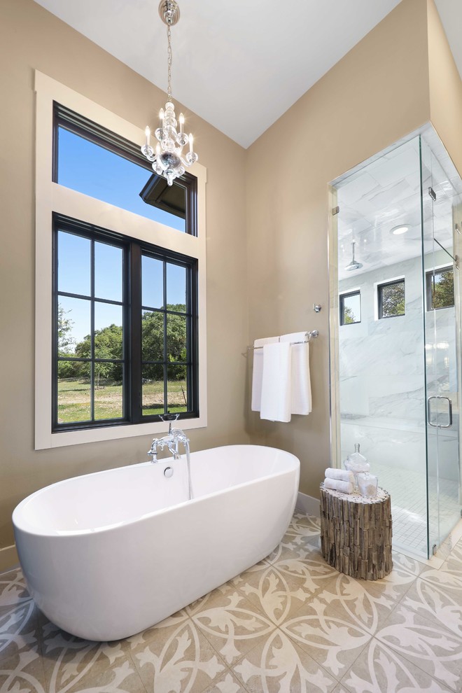 This is an example of a transitional master bathroom in Austin with a freestanding tub, a corner shower, beige walls, cement tiles, beige floor and a hinged shower door.