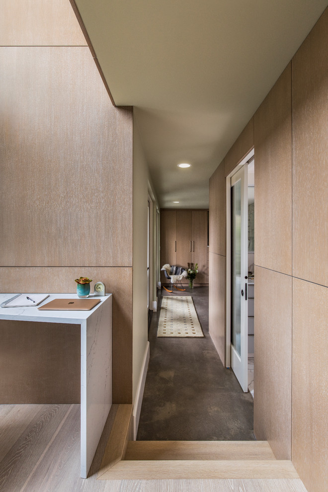 Design ideas for a modern hallway in Portland with light hardwood floors.