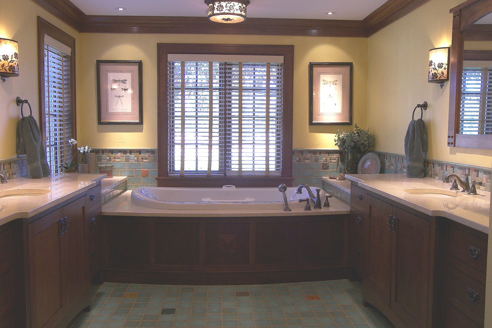 Mid-sized transitional master bathroom in Wichita with shaker cabinets, dark wood cabinets, a drop-in tub, multi-coloured tile, yellow walls, mosaic tile floors, an undermount sink, marble benchtops and mosaic tile.