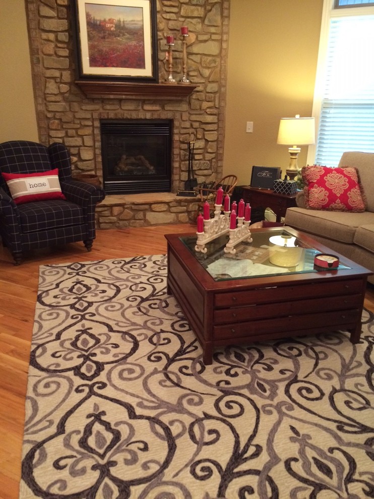 Example of a mid-sized transitional open concept light wood floor living room design with brown walls, a corner fireplace and a stone fireplace